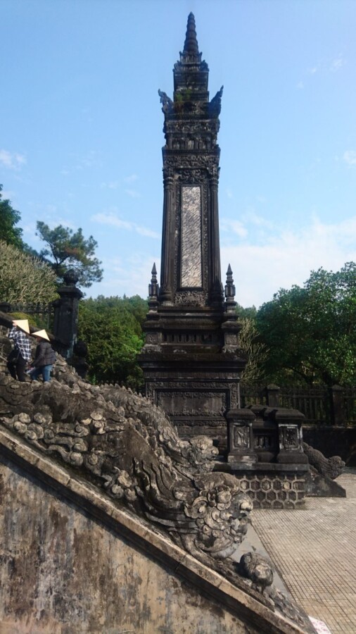 The steps up to Khai Dinh's tomb are flanked by two of these needles and adorned with many dragons