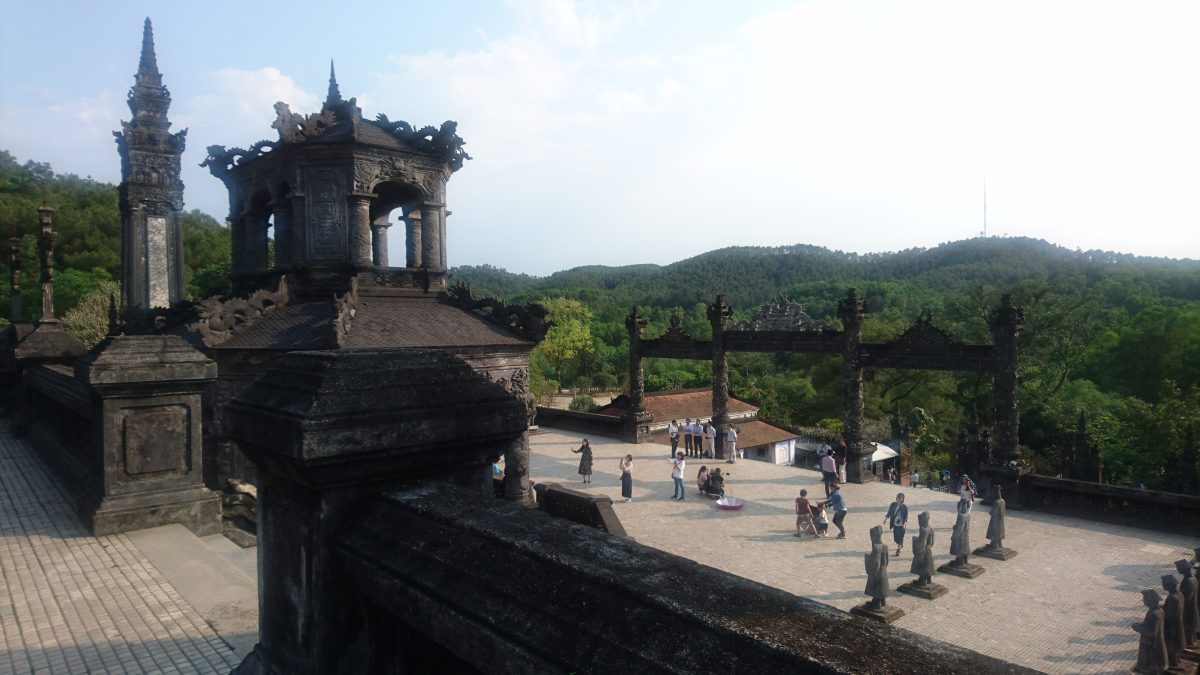 Looking down from the tomb, over the main gate to the jungle beyond, the tomb of Khai Dinh is splendid in its isolation